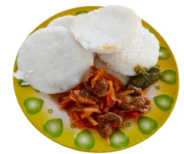 A plated canteen meal with a starchy side and a meat sauce.