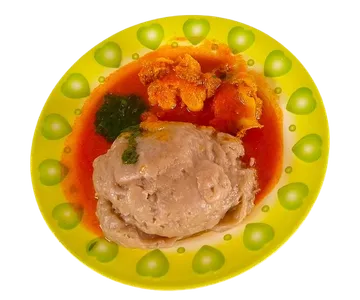 A plated canteen meal with a meat and vegetable sauce.
